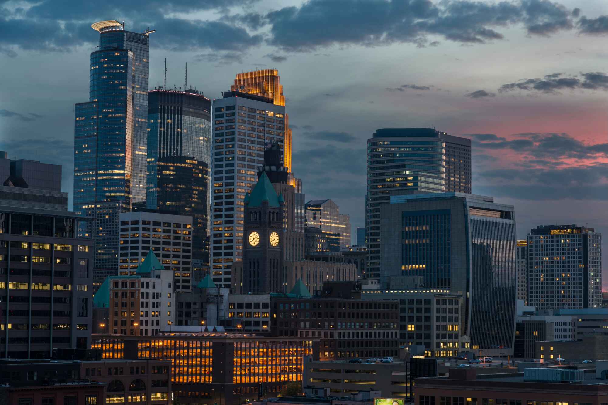 Downtown Minneapolis real estate and condo living — city skyline views, modern loft interiors, and street-level shots that capture the walkable, urban lifestyle of downtown neighborhoods.